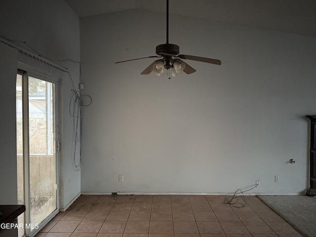 tiled spare room featuring lofted ceiling and ceiling fan