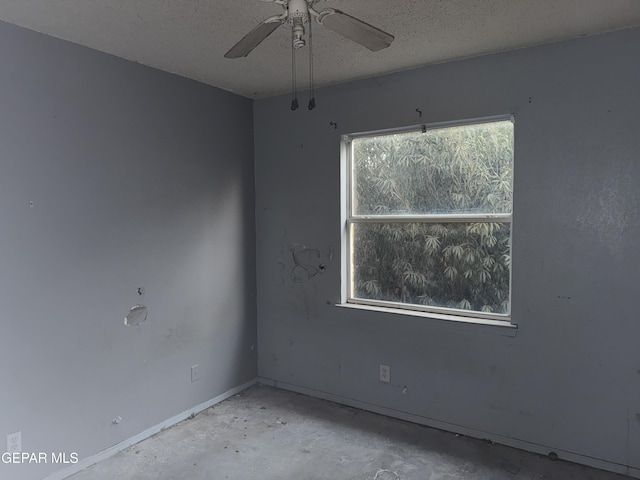 empty room featuring ceiling fan and a textured ceiling