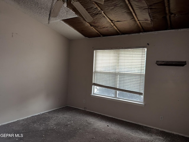 empty room with vaulted ceiling and ceiling fan