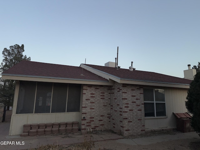 view of side of property with a sunroom