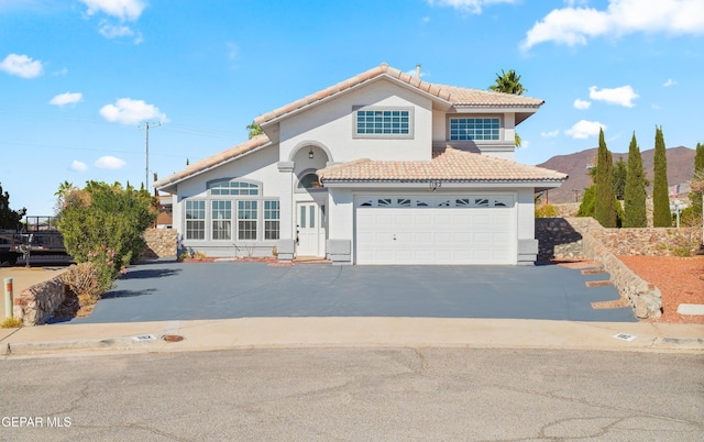 view of front of home featuring a garage and a mountain view