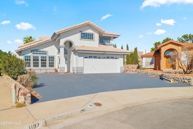 mediterranean / spanish house featuring a garage