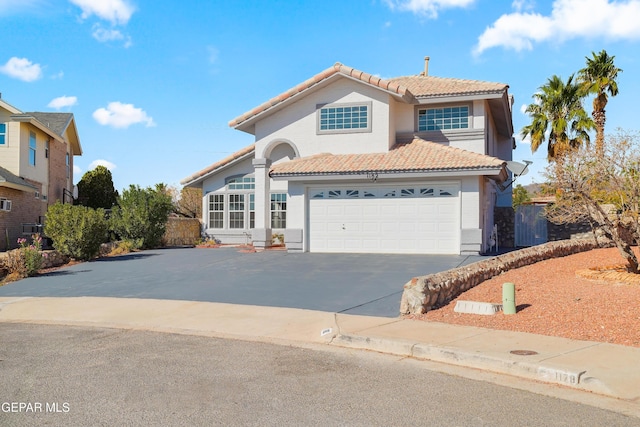 mediterranean / spanish-style home with a garage