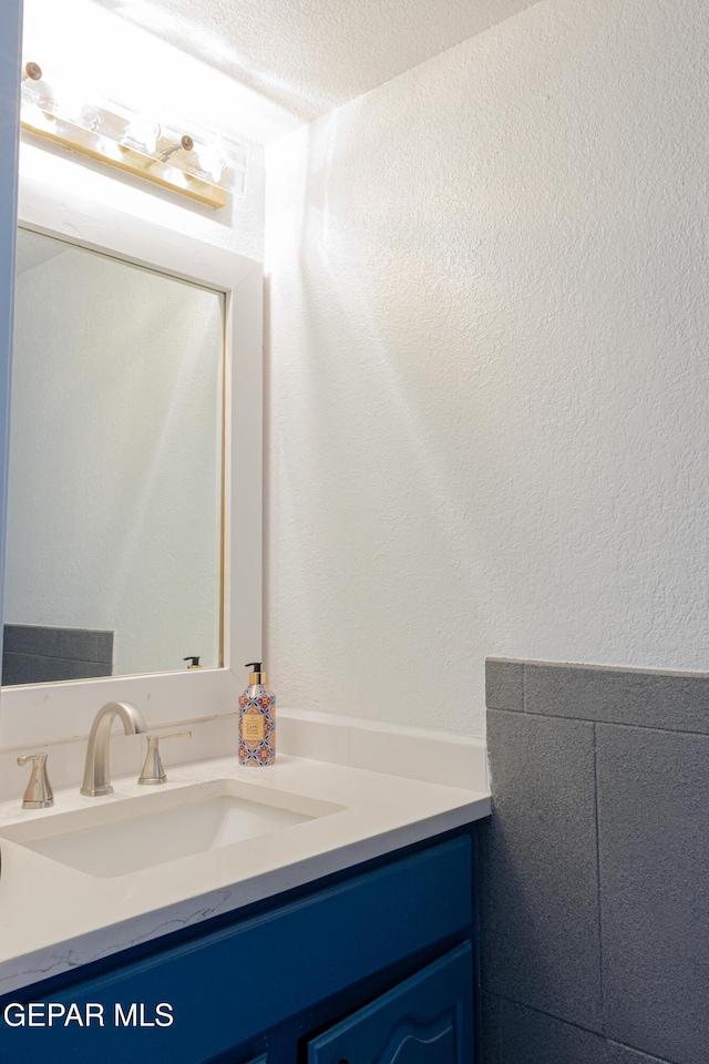 bathroom featuring vanity and a textured ceiling