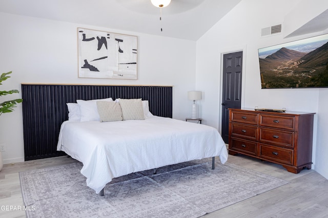 bedroom featuring lofted ceiling, ceiling fan, and light hardwood / wood-style floors