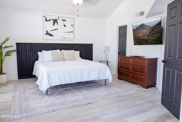 bedroom with lofted ceiling, light wood-type flooring, and ceiling fan