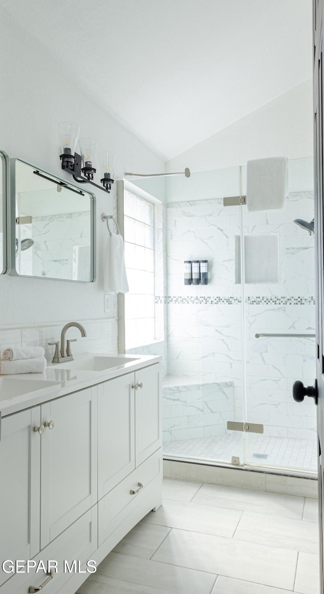 bathroom with vanity, tile patterned flooring, lofted ceiling, and an enclosed shower