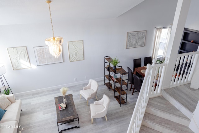 interior space with vaulted ceiling, a notable chandelier, and light hardwood / wood-style flooring