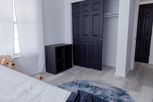 bedroom featuring light hardwood / wood-style floors and a closet