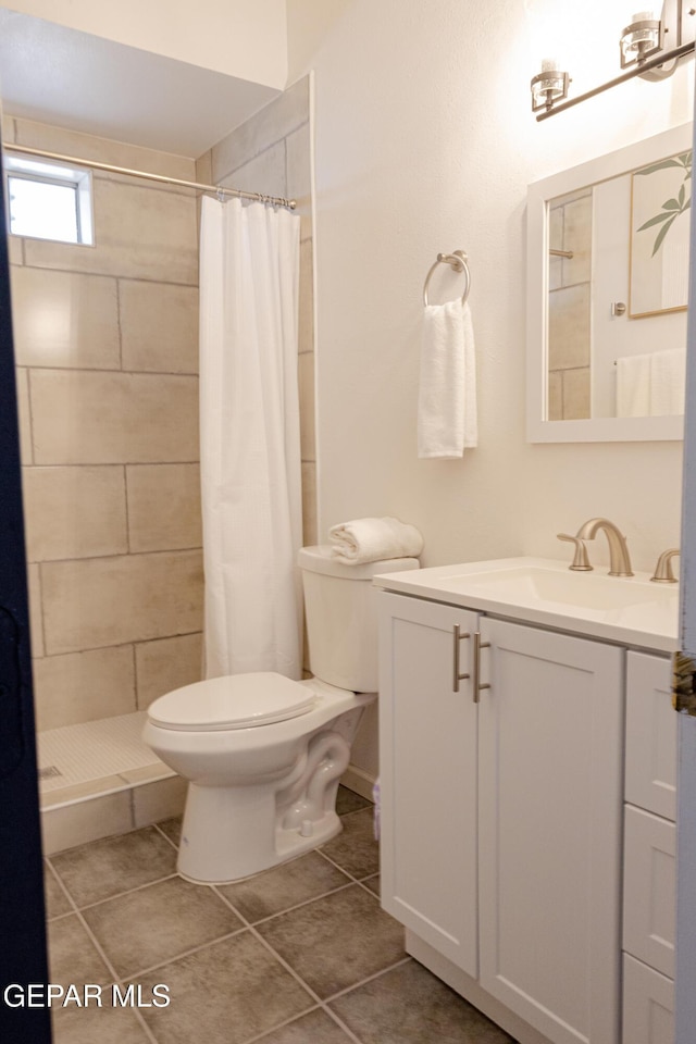 bathroom featuring toilet, vanity, tile patterned flooring, and a shower with curtain