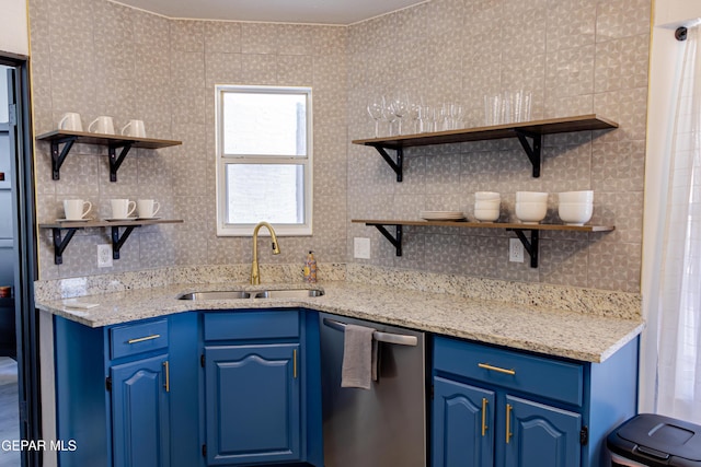 kitchen featuring sink, dishwasher, blue cabinets, and light stone counters