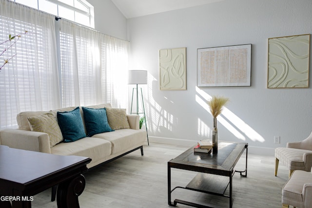 living room featuring light wood-type flooring and lofted ceiling