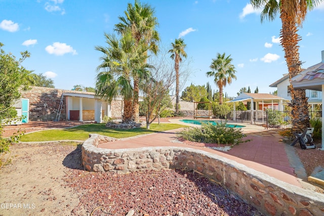 view of yard featuring a fenced in pool and a patio