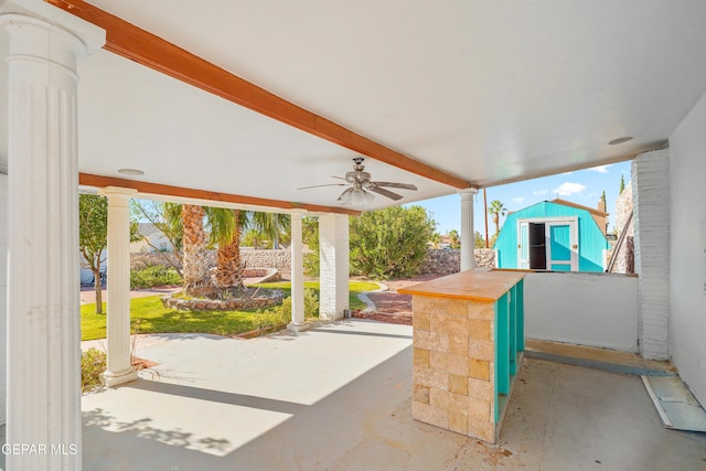 view of patio with ceiling fan and a storage shed