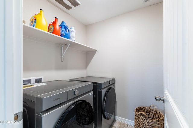 laundry room featuring separate washer and dryer