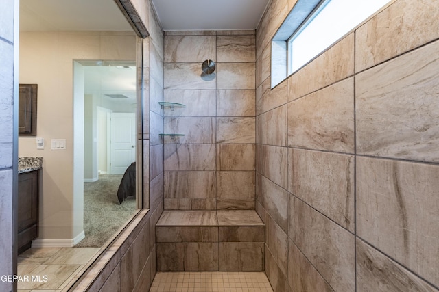 bathroom featuring vanity and tiled shower