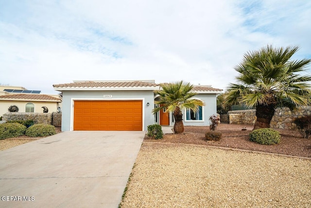 mediterranean / spanish house with a garage