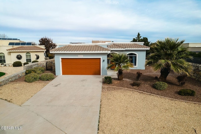 mediterranean / spanish house with a garage