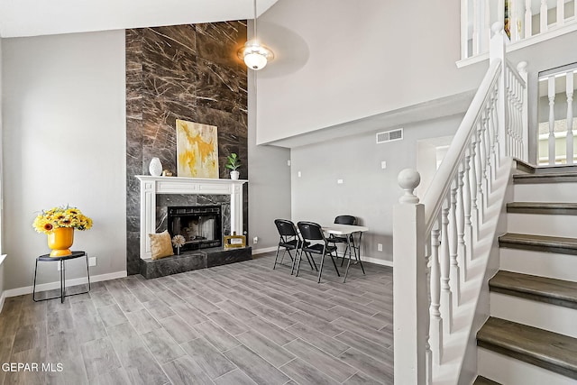 interior space featuring a towering ceiling and a premium fireplace