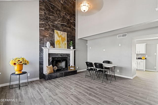 dining room with ceiling fan and a fireplace