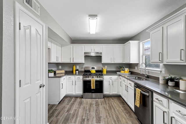 kitchen featuring appliances with stainless steel finishes, sink, and white cabinets