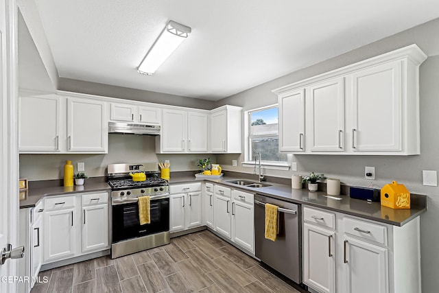 kitchen featuring stainless steel appliances, sink, and white cabinets