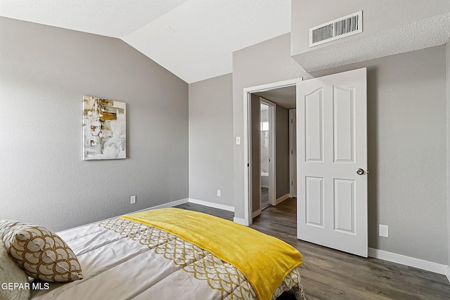 bedroom with lofted ceiling and dark hardwood / wood-style flooring