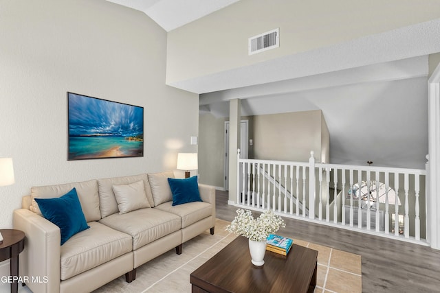 living room featuring vaulted ceiling and wood-type flooring