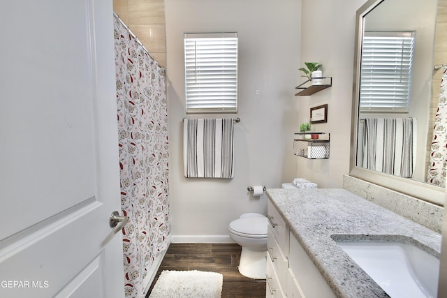 bathroom featuring toilet, hardwood / wood-style flooring, and vanity