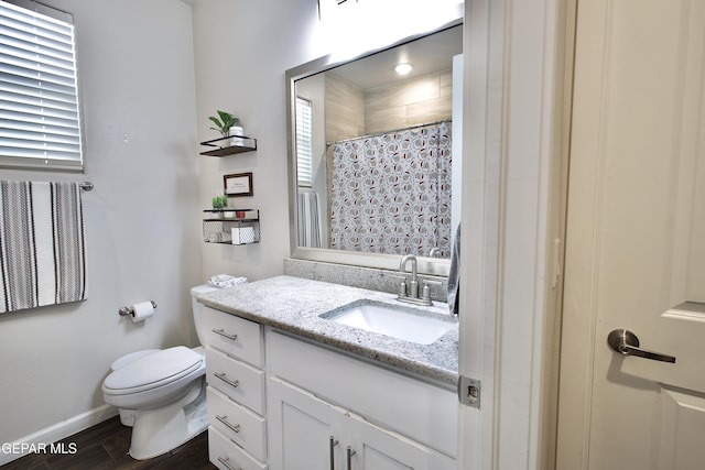 bathroom with toilet, vanity, hardwood / wood-style flooring, and walk in shower