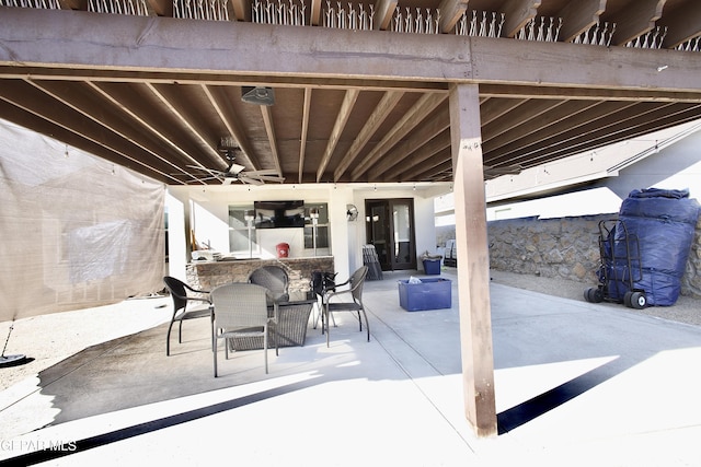 view of patio / terrace with a bar and ceiling fan