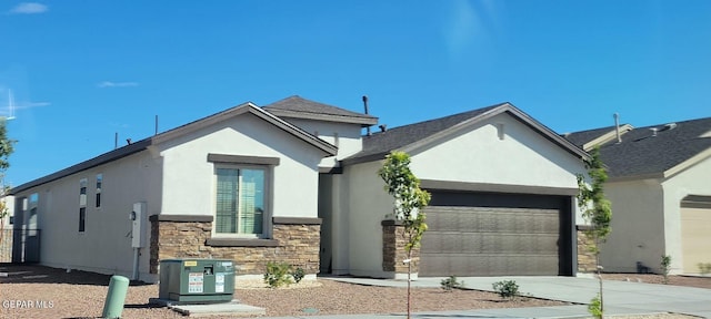 view of front of house featuring a garage and central AC