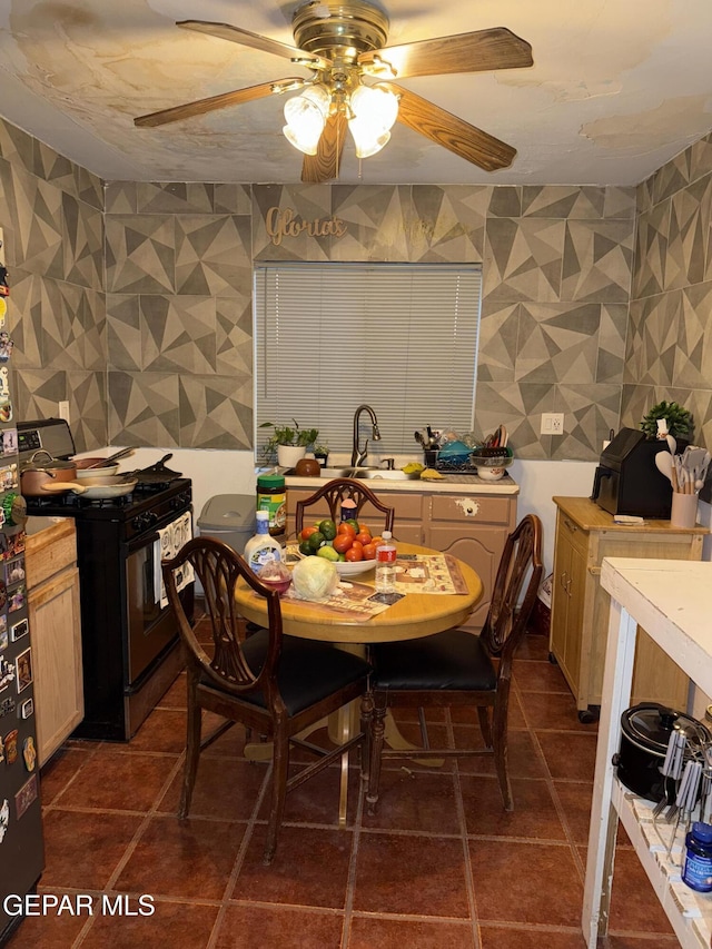 dining area featuring ceiling fan and sink