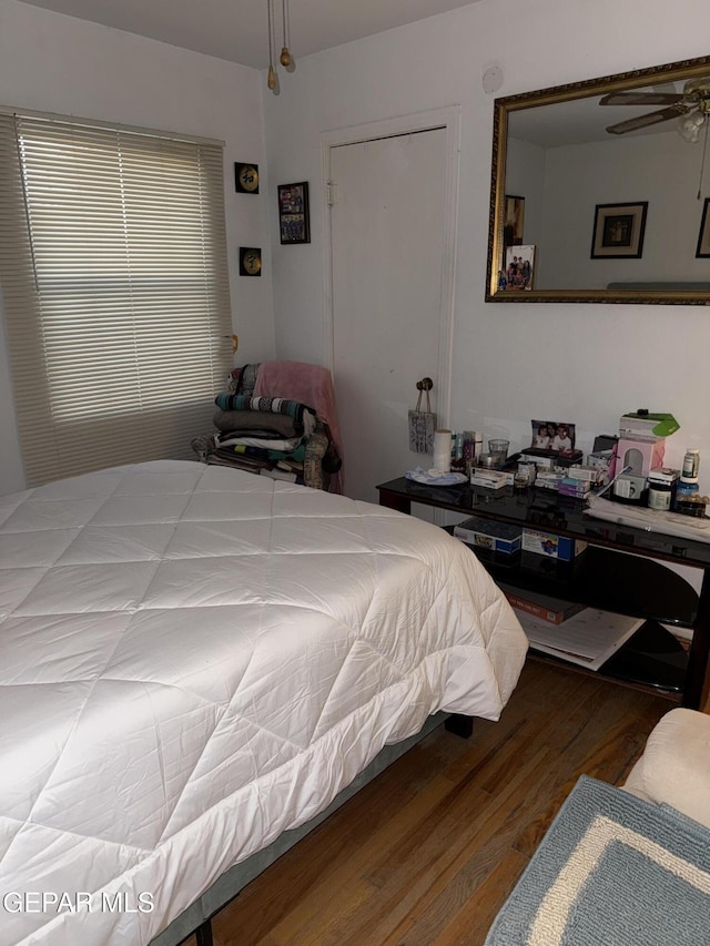 bedroom with hardwood / wood-style floors and ceiling fan