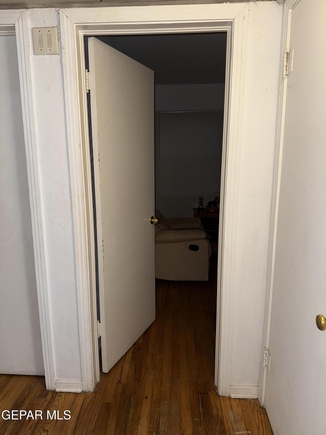 corridor featuring dark hardwood / wood-style flooring