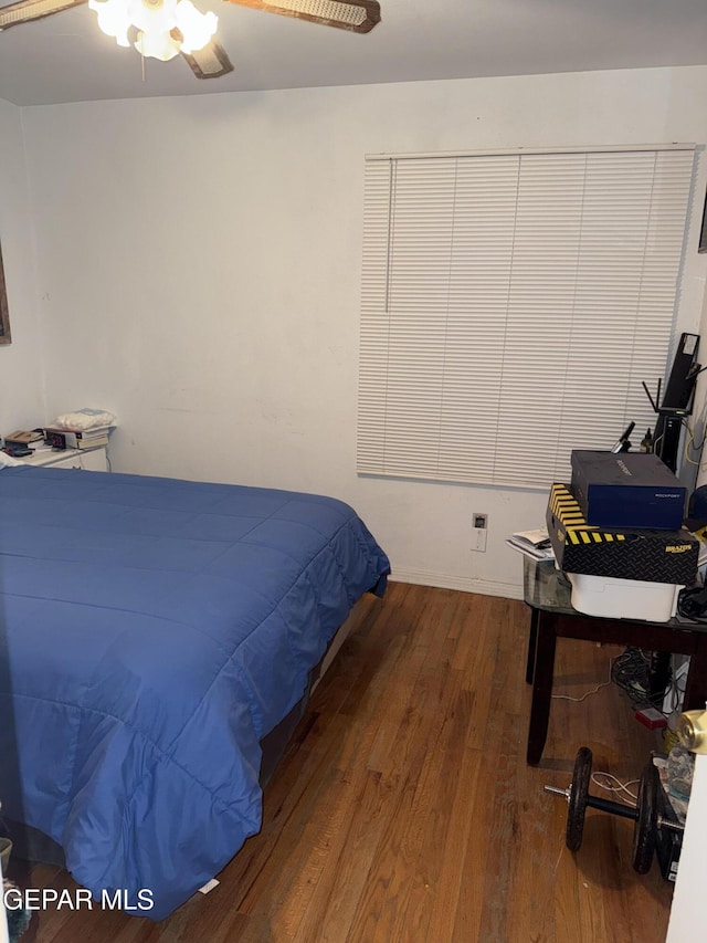 bedroom with ceiling fan and hardwood / wood-style flooring