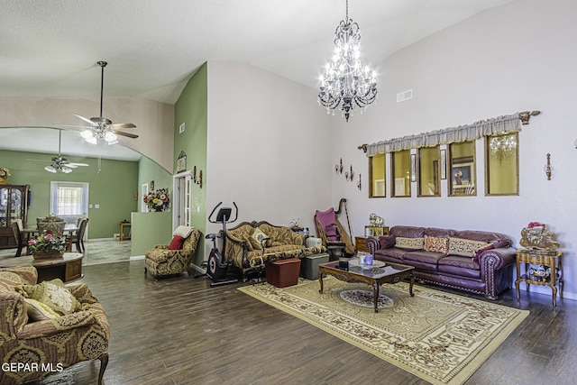 living room with lofted ceiling, dark wood-type flooring, and ceiling fan with notable chandelier