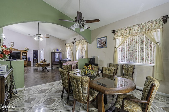 dining room with lofted ceiling, ceiling fan, and wood-type flooring