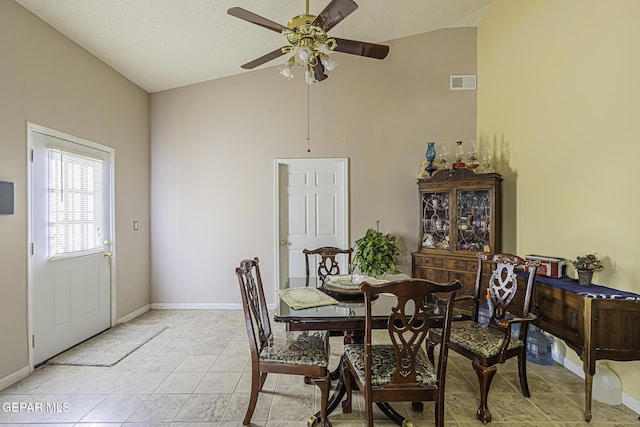 tiled dining space featuring vaulted ceiling and ceiling fan