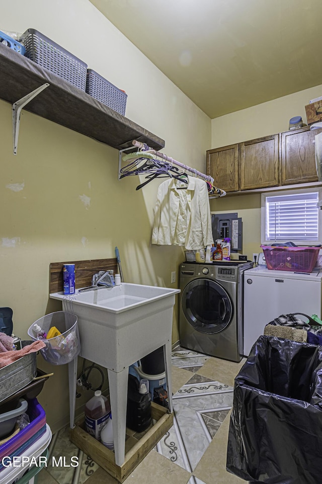 laundry area with washer and dryer and cabinets