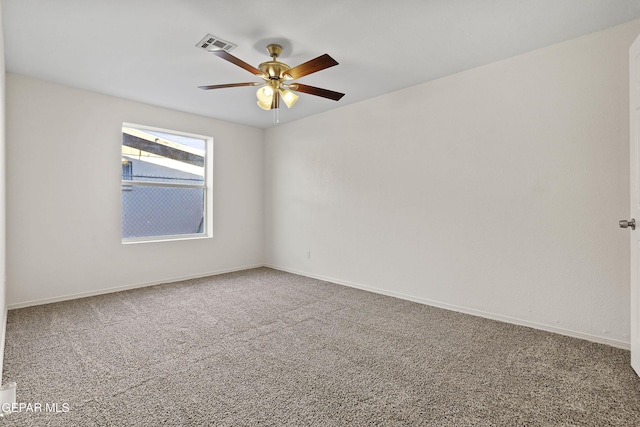 unfurnished room with baseboards, carpet, visible vents, and a ceiling fan