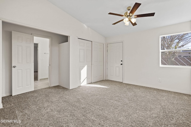 unfurnished bedroom with lofted ceiling, ceiling fan, and carpet