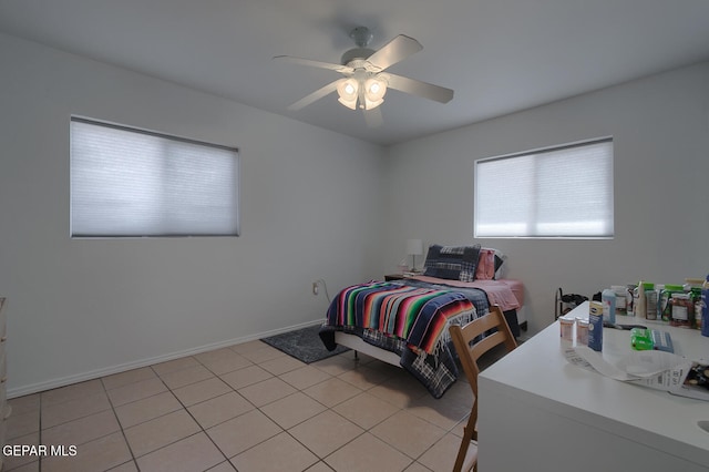 tiled bedroom featuring ceiling fan