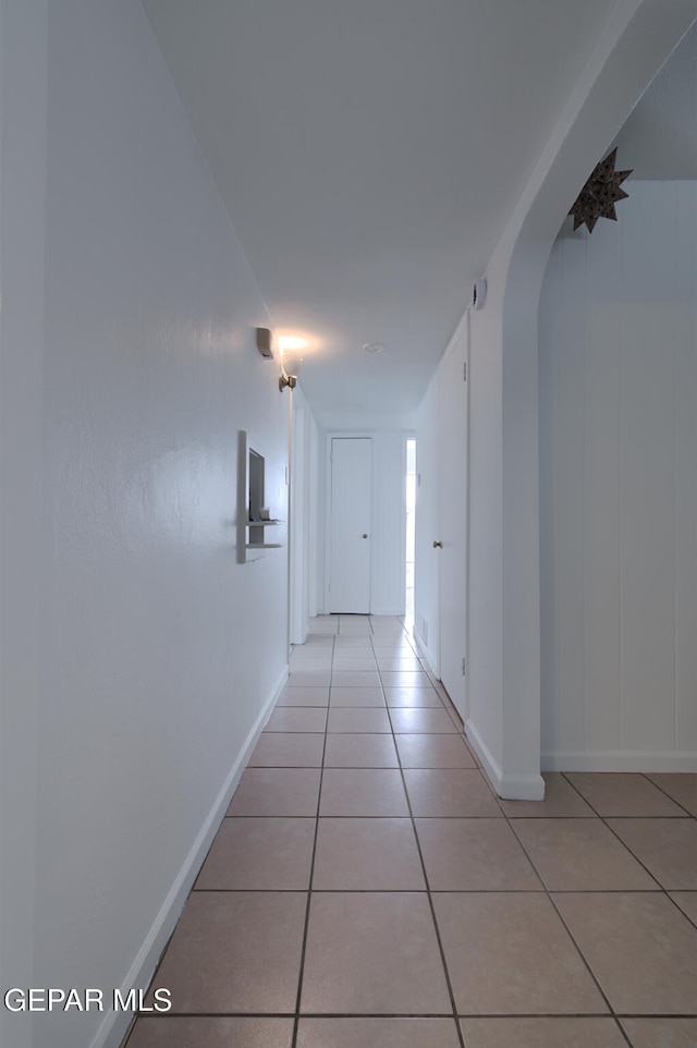 hall featuring light tile patterned flooring