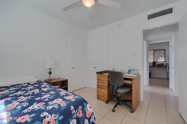 bedroom with ceiling fan and light tile patterned floors