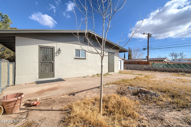 back of property with a patio