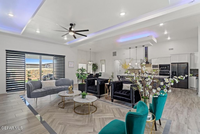 living room with ceiling fan and light hardwood / wood-style floors