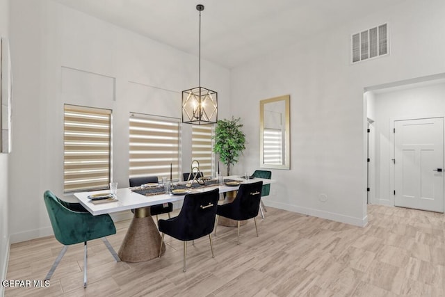 dining area featuring a chandelier and light hardwood / wood-style floors