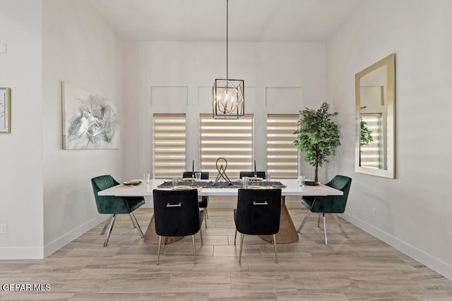 dining area with a notable chandelier and light wood-type flooring