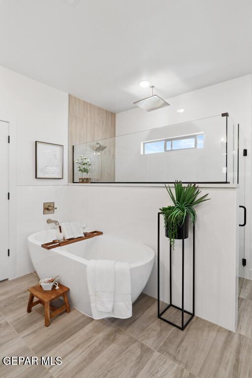 bathroom with separate shower and tub